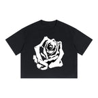 Studio Ruban black 100% cotton boxy drop shoulder crop t-shirt with white rose graphic.