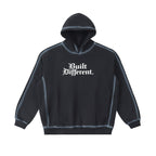 Studio Ruban black cotton blend oversized hoodie with white 'Built Different.' graphic and contrast stitching.