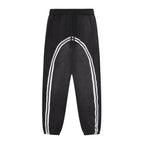 Studio Ruban black fleece jogger sweatpants with white contrast tape detail and drawstring waist.