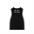 Studio Ruban black mini dress with white trim, spaghetti straps, and "Be You, Not Them" graphic.
