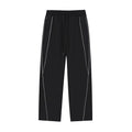 Studio Ruban black cotton blend sweatpants with white reflective piping and drawstring waist.