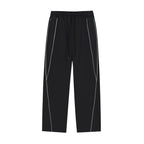Studio Ruban black cotton blend sweatpants with white reflective piping and drawstring waist.