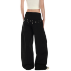 Studio Ruban Risa black wide leg cargo pants with studded belt and utilitarian pockets.