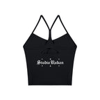 Studio Ruban black solid color yoga sports bra with spaghetti straps and a cutout detail on the back.