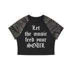 Studio Ruban Women's black crop t-shirt with camouflage raglan sleeves and white gothic text graphic.