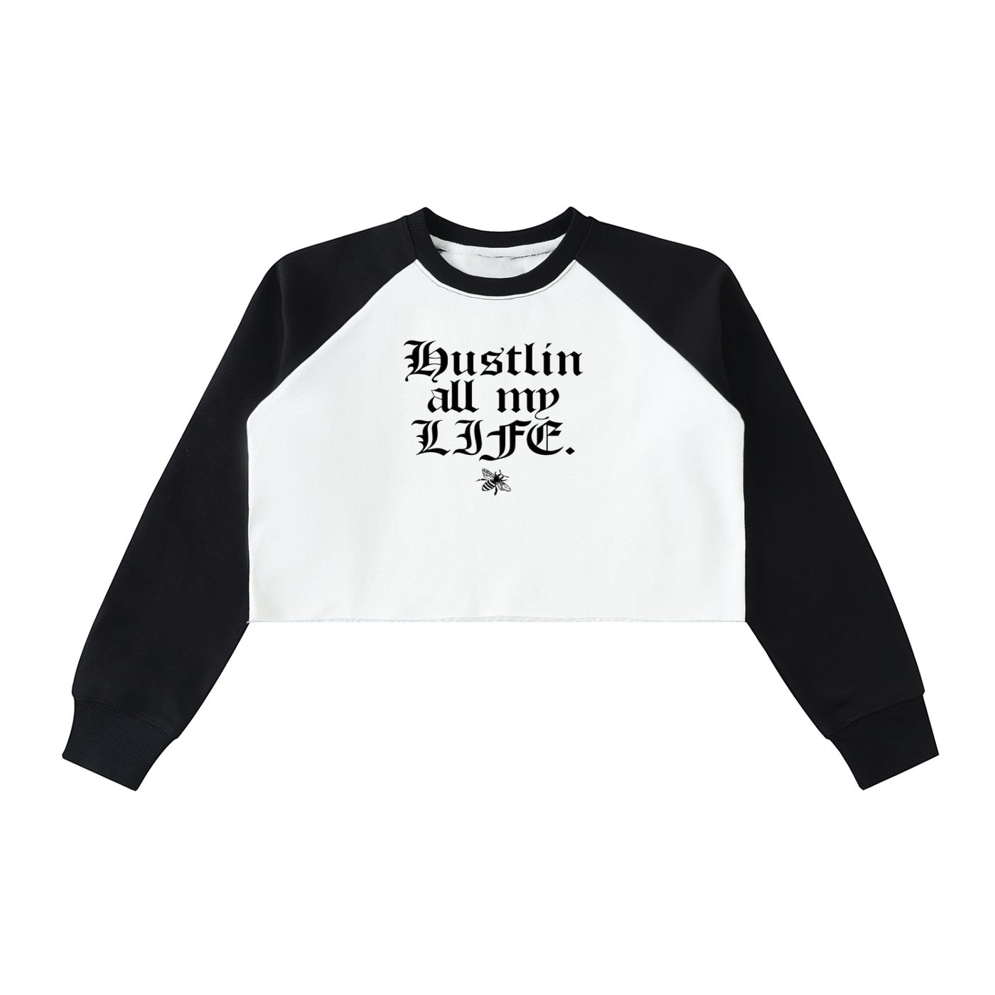 Studio Ruban white crop sweatshirt with black raglan sleeves and raw hem. Features gothic text "Hustlin all my LIFE." and a bee graphic.