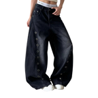 Studio Ruban dark washed baggy jeans with grommet details down the sides and a wide leg.