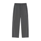 Studio Ruban dark grey straight-leg sweatpants with white piping detail and drawstring waist. Cotton blend.