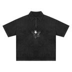 Studio Ruban heavyweight snow-washed black cotton polo t-shirt with short sleeves and a cherub graphic.