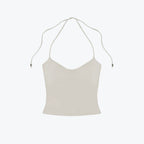 Studio Ruban Kiki halterneck top in light beige, soft-touch fabric with adjustable tie-back.