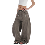 Studio Ruban Kisa taupe wide leg denim jeans with square stud embellishments and a black studded belt.