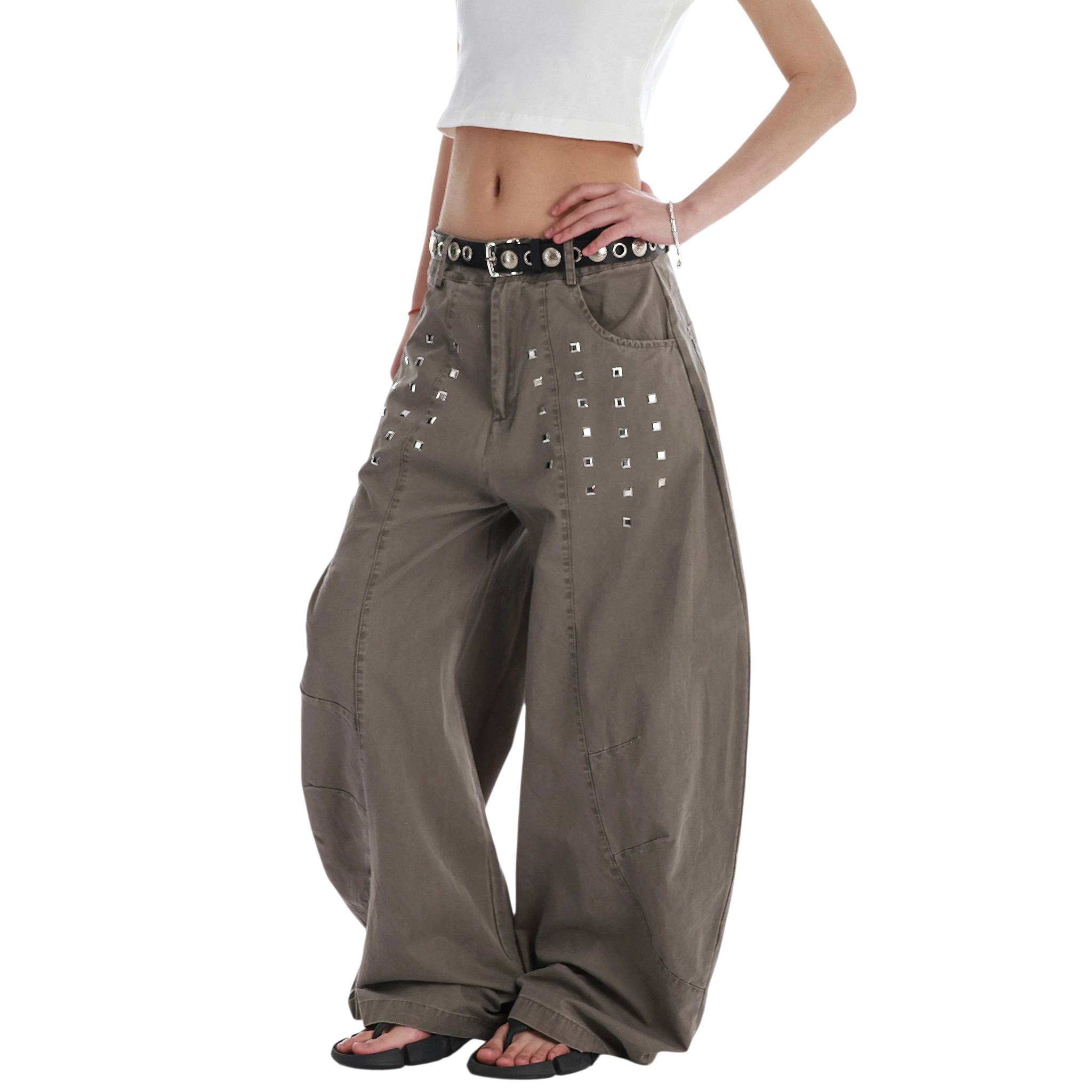 Studio Ruban Kisa taupe wide leg denim jeans with square stud embellishments and a black studded belt.