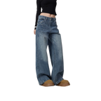 Studio Ruban mid-wash denim wide leg jeans with scattered rhinestone embellishments on pockets and legs.