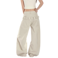 Studio Ruban Risa wide leg cargo pants in stone cotton blend with studded belt and utility pockets.