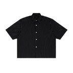 Studio Ruban black short-sleeve button-up shirt with thin white vertical pinstripes and a lapel collar.