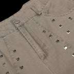 Studio Ruban taupe wide leg denim jeans with square stud embellishments and a button closure.