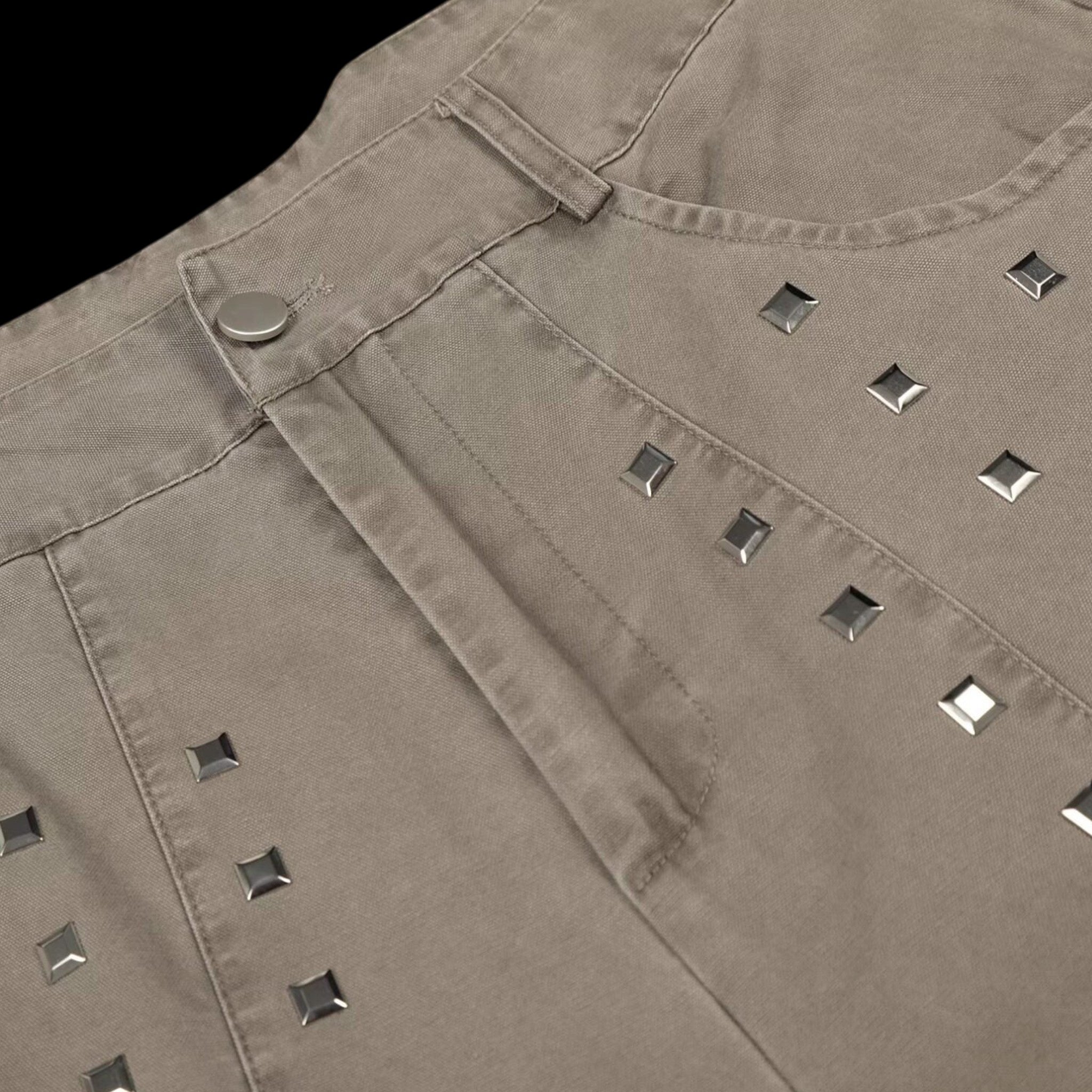 Studio Ruban taupe wide leg denim jeans with square stud embellishments and a button closure.