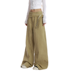 Studio Ruban Tiri khaki wide leg wrap pants with button closure and exaggerated flare. Cotton blend.